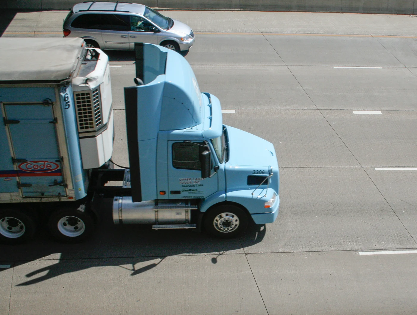 A light blue semi truck travelling along Interstate 94 in Saint Paul, Minnesota.