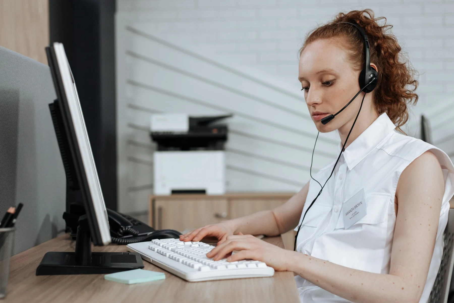 A colleague handling a conversation at her workstation