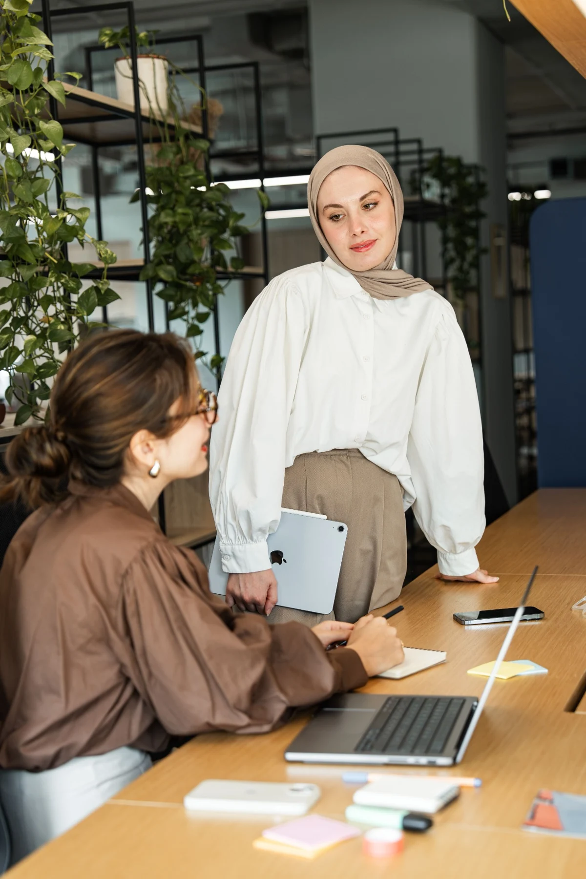 Two colleagues listening and working through an idea together